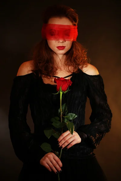 Halloween witch with rose on dark background — Stock Photo, Image