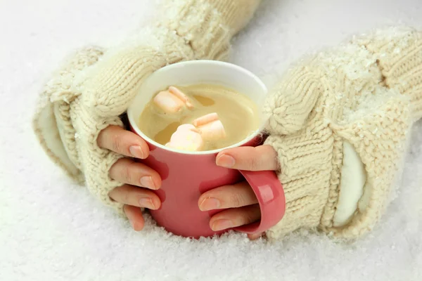 Female hands with hit drink, on light background — Stock Photo, Image