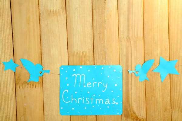 Signboard with words Merry Christmas on wooden table background close-up — Stock Photo, Image