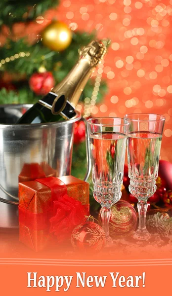 Composition with Christmas decorations and two champagne glasses, on bright background — Stock Photo, Image