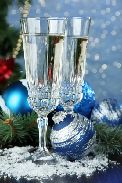 Composition with Christmas decorations and two champagne glasses, on bright background — Stock Photo, Image