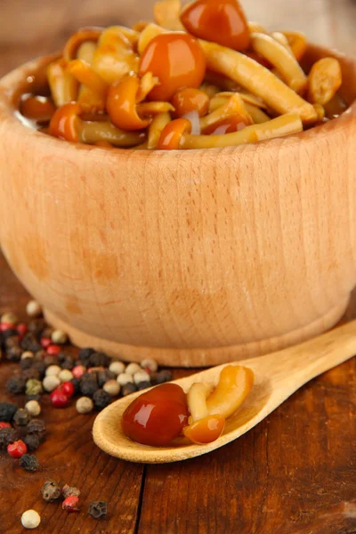 Mushrooms in bowl, on wooden background — Stock Photo, Image