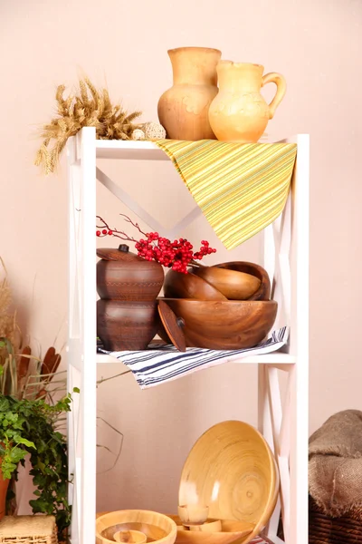 Красивые белые полки с посудой и декором, на фоне цветной стены — стоковое фото