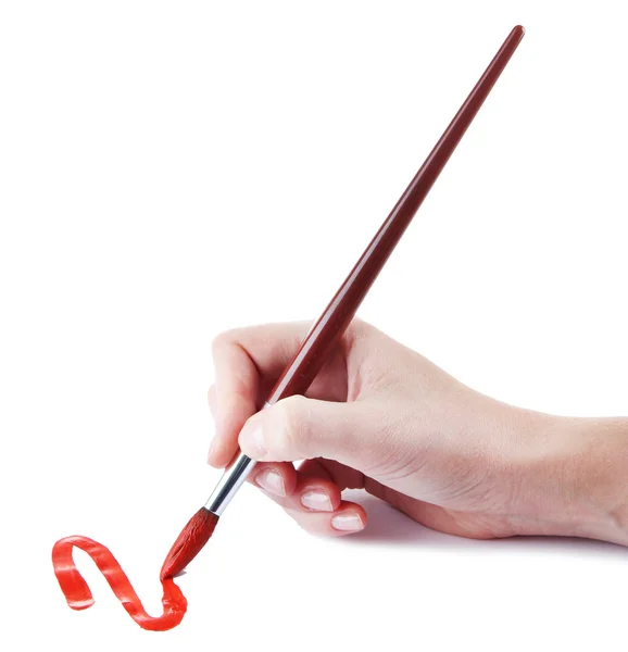 Hand holding brush with red paint isolated on white — Stock Photo, Image