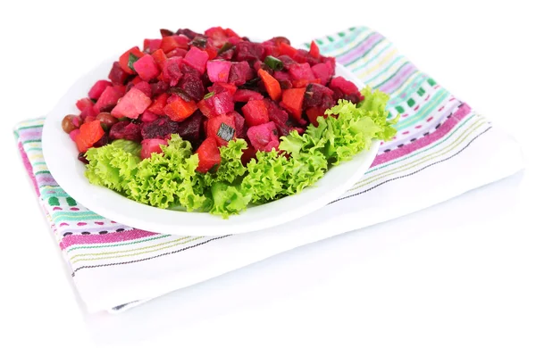 Beet salad on plate on napkin isolated on white — Stock Photo, Image