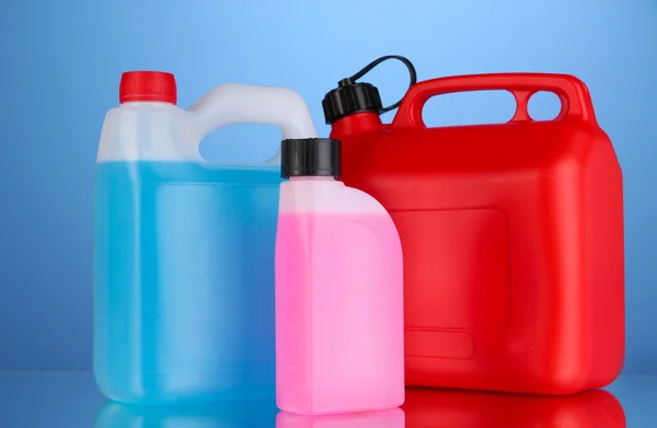 Liquids for car in canisters on blue background — Stock Photo, Image