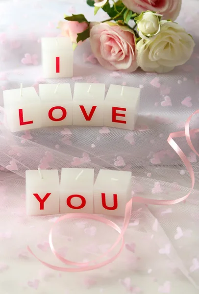 Candles with printed sign I LOVE YOU, on light background — стоковое фото