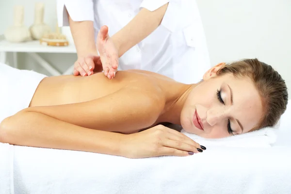 Beautiful young woman having back massage close up — Stock Photo, Image
