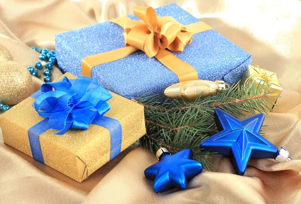 Schöne helle Geschenke und Weihnachtsdekoration, auf Seidenstoff — Stockfoto