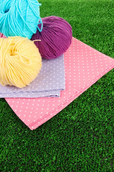 Multicolored clews with napkins on grass closeup — Stock Photo, Image