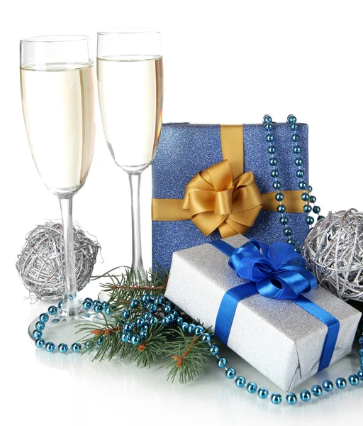 Glasses of champagne with gift boxes isolated on white — Stock Photo, Image