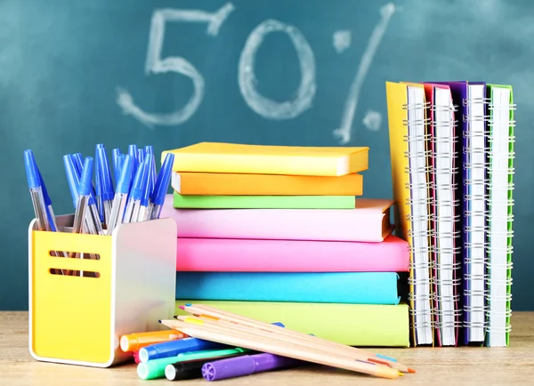 Office supplies on table on school board background — Stock Photo, Image