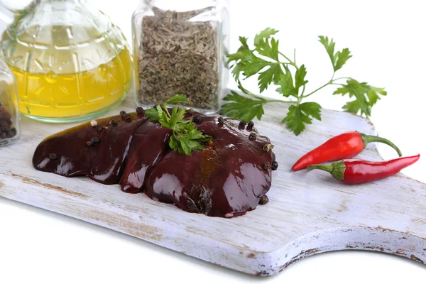 Raw liver on wooden board with spices and condiments isolated on white — Stock Photo, Image