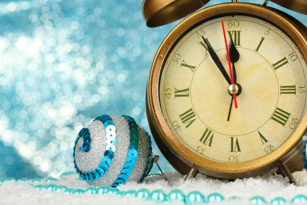 Composition of clock and christmas decorations on bright background — Stock Photo, Image