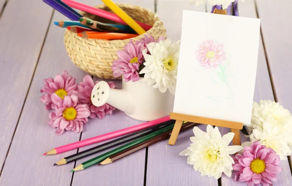 Composition of flowers and  easel with picture — Stock Photo, Image