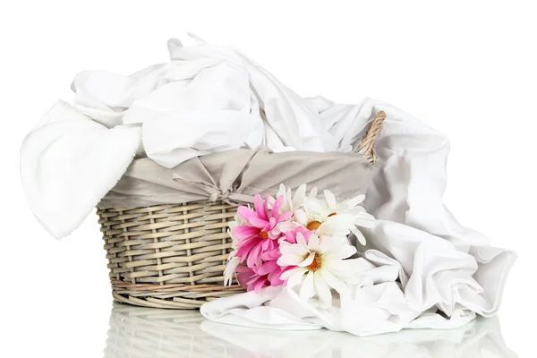 Rumpled bedding sheets in wicker basket — Stock Photo, Image