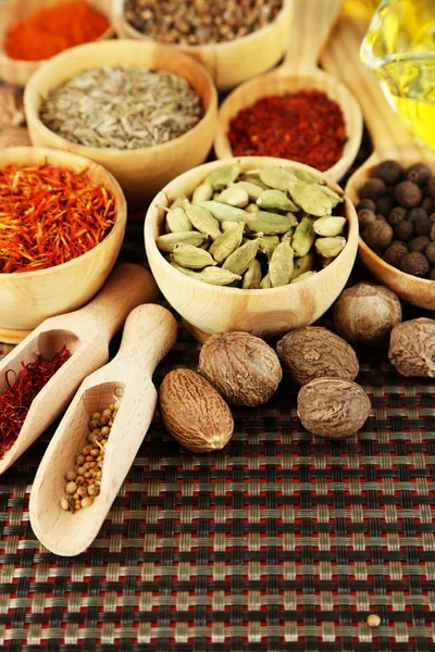 Many different spices and fragrant herbs on wooden table close-up — Stock Photo, Image