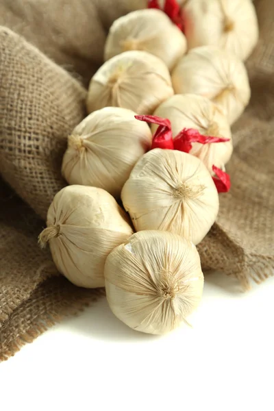 Vintage garlic and pepper decoration, on sackcloth, isolated on white — Stock Photo, Image