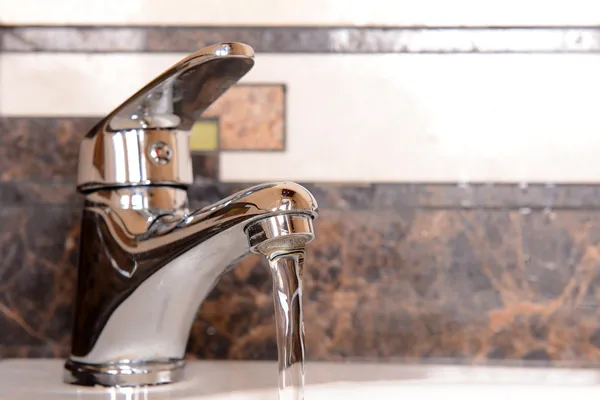 Ceramic sink with chrome fixture, close up — Stock Photo, Image