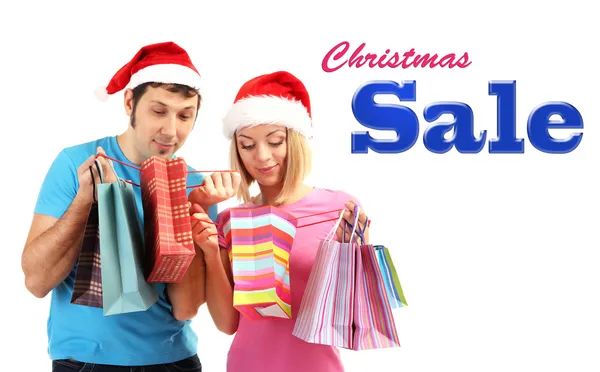 Couple in Santa hats shopping — Stock Photo, Image