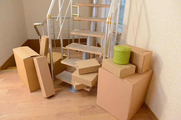 Stack of cartons near stairs: moving house concept — Stock Photo, Image