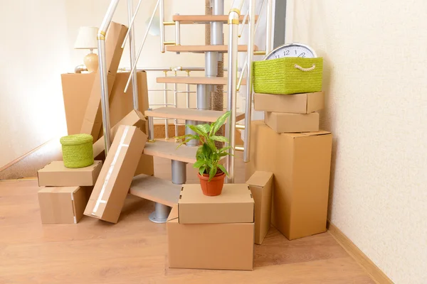 Stack of cartons near stairs: moving house concept — Stock Photo, Image