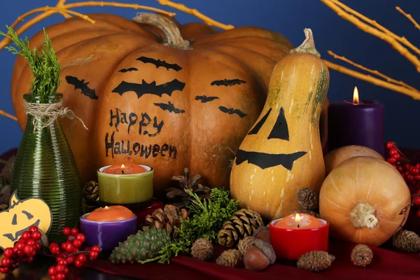 Samenstelling voor halloween met pompoenen en kaarsen op blauwe achtergrond — Stockfoto