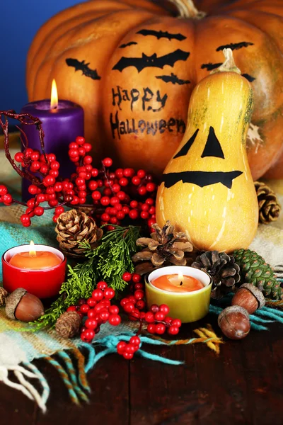 Composition for Halloween with pumpkins and candles on color background — Stock Photo, Image