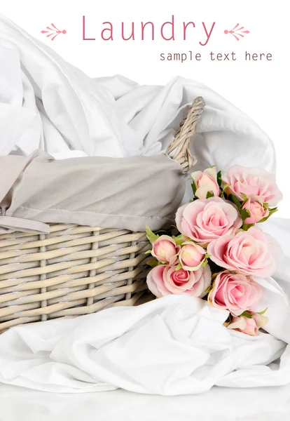 Rumpled bedding sheets in wicker basket isolated on white — Stock Photo, Image