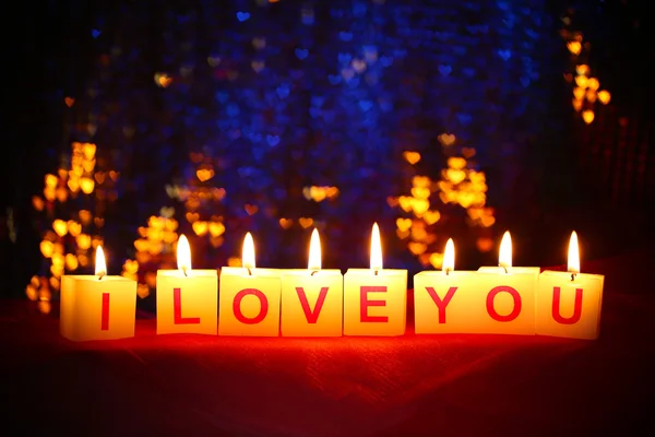 Candles with printed sign I LOVE YOU,on blur lights background — Stock Photo, Image