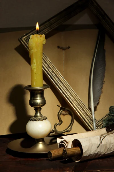 Old candle on table in room — Stock Photo, Image