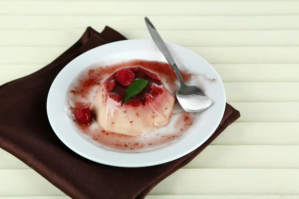 Panna Cotta with raspberry sauce, on wooden background — Stock Photo, Image