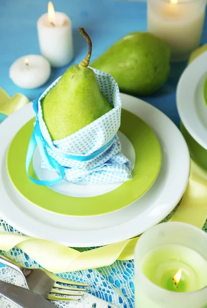 Peren in servetten op platen op houten tafel close-up — Stockfoto