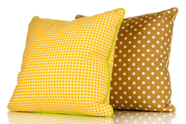 Yellow and brown bright pillows isolated on white