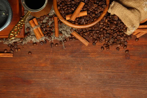 Coffee beans, metal turk and coffee mill on wooden background with copy space — Stock Photo, Image