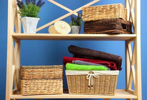 Beautiful white shelves with different home related objects, on color wall background — Stock Photo, Image