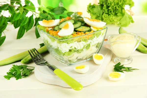 Delicious salad with eggs, cabbage and cucumbers on wooden table — Stock Photo, Image