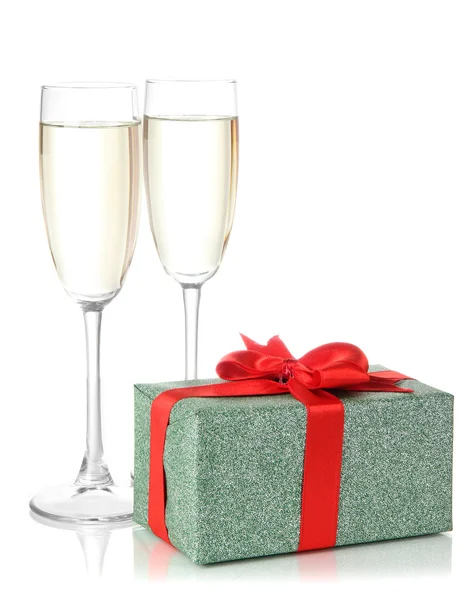 Glasses of champagne with gift box isolated on white — Stock Photo, Image