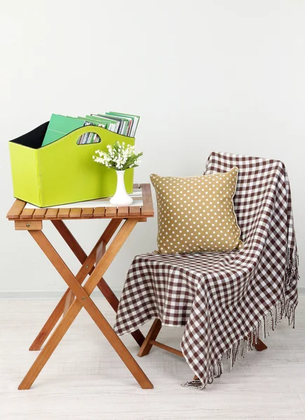 Magazines and folders in green box on table in room — Stock Photo, Image