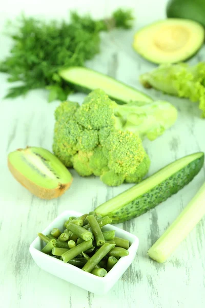 Fresh green vegetables, on wooden background — Stock Photo, Image