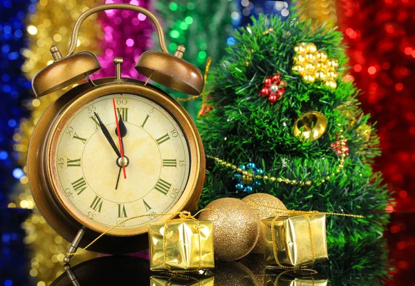 Composition of clock and christmas decorations on bright background — Stock Photo, Image