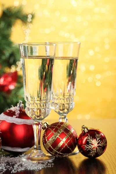 Composition with Christmas decorations and two champagne glasses, on bright background — Stock Photo, Image