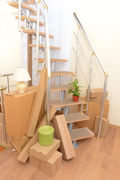 Stack of cartons near stairs: moving house concept — Stock Photo, Image