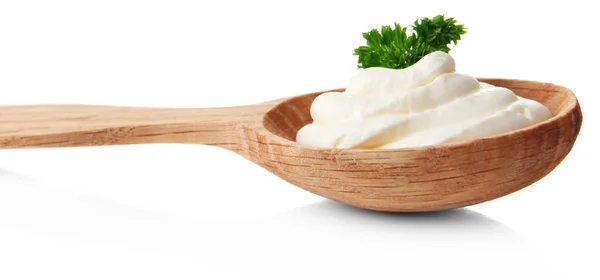 Sour cream in spoon isolated on white — Stock Photo, Image