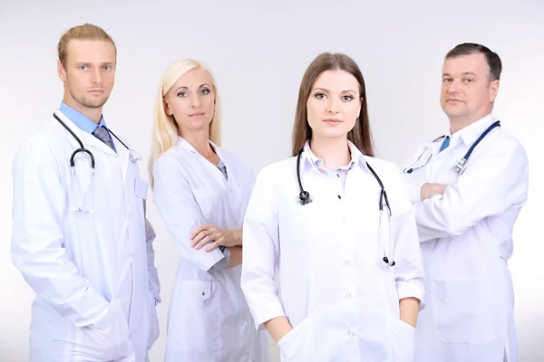 Medical workers on grey background — Stock Photo, Image