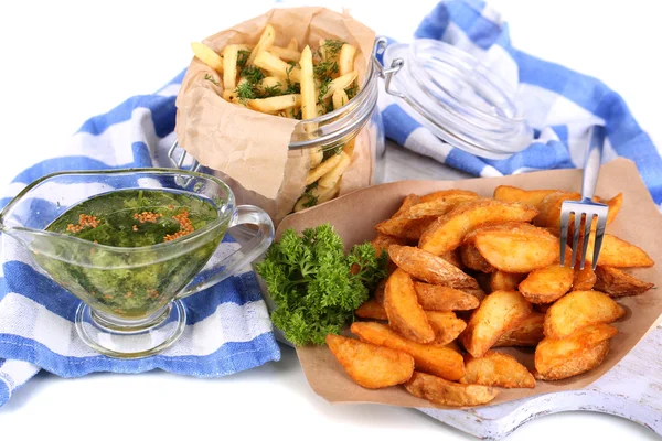 Home potatoes on tracing paper on wooden board near napkin isolated on white — Stock Photo, Image