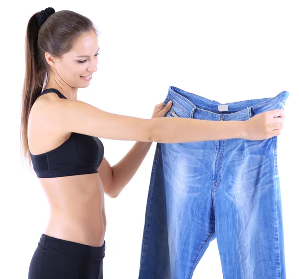 Slim meisje met grote jeans geïsoleerd op wit — Stockfoto