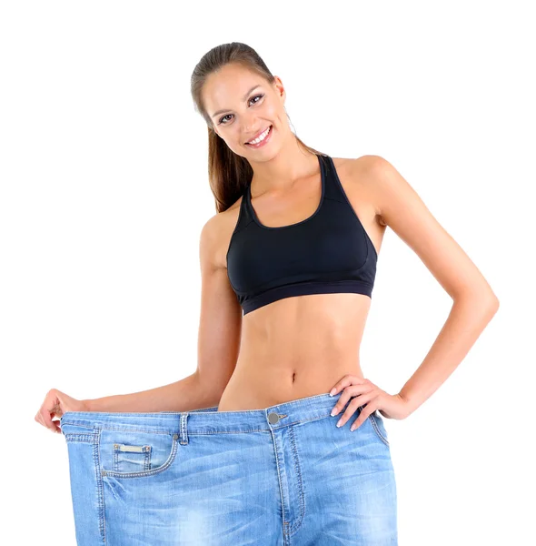 Menina magro em jeans grandes isolado em branco — Fotografia de Stock