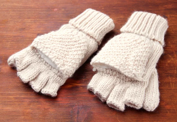 Wool fingerless gloves, on wooden background — Stock Photo, Image
