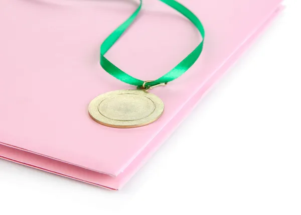 Medal for achievement in education and notebook isolated on white — Stock Photo, Image